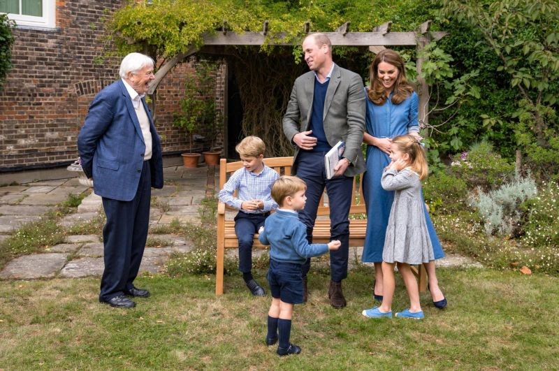 A handout photo released by Britain's Prince William and Cathrine, Duchess of Cambridge, Prince George (seated), Princess Charlotte and Prince Louis with David Attenborough after Prince William and David Attenborough attended an outdoor screening of the upcoming Attenborough's feature film, in the gardens of Kensington Palace, in London, Britain, September 24, 2020. (Duke and Duchess of Cambridge/Kensington Palace/Handout via REUTERS)
